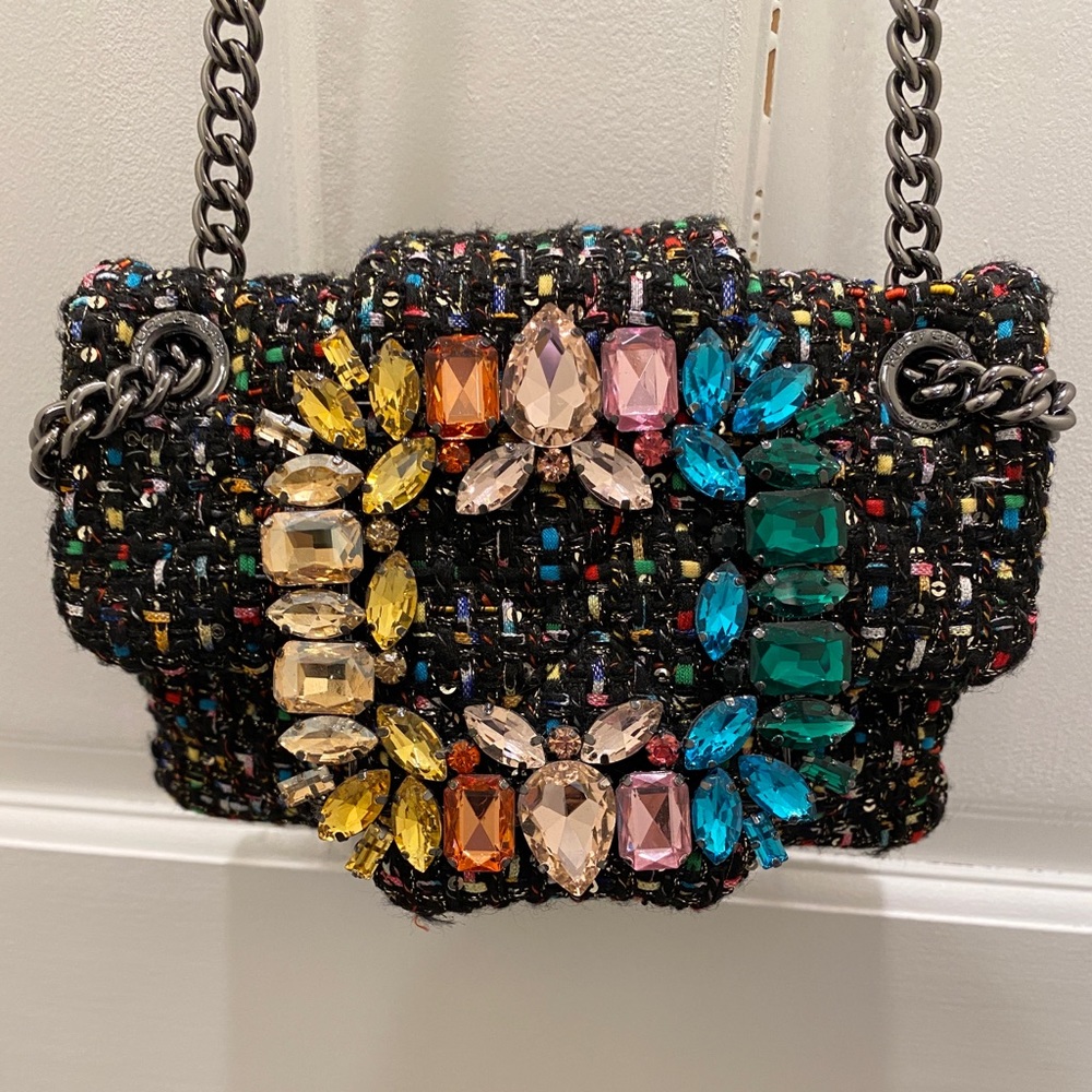 This bag is a multicolored tweed with black being main color. Worn twice.